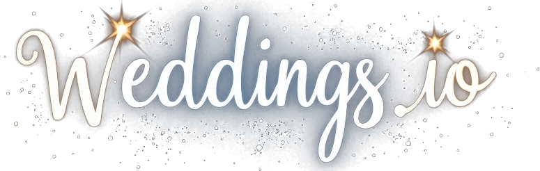 Weddings.io logo in white cursive script surrounded by glowing sparkles